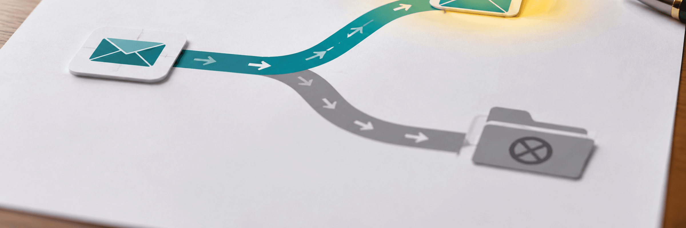 An email message at a crossroads between a bright inbox and a greyed-out spam folder